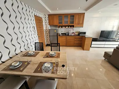 Modern open-layout kitchen and dining area with stylish decor and appliances
