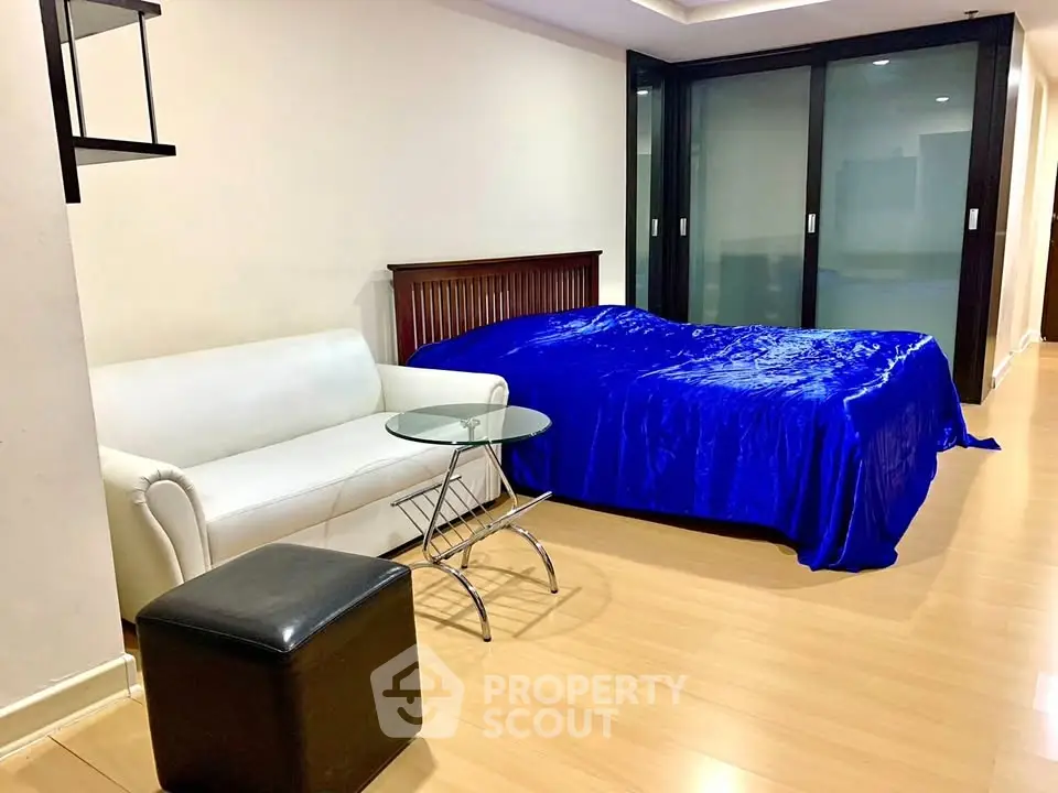 Spacious bedroom with modern decor and sliding glass doors