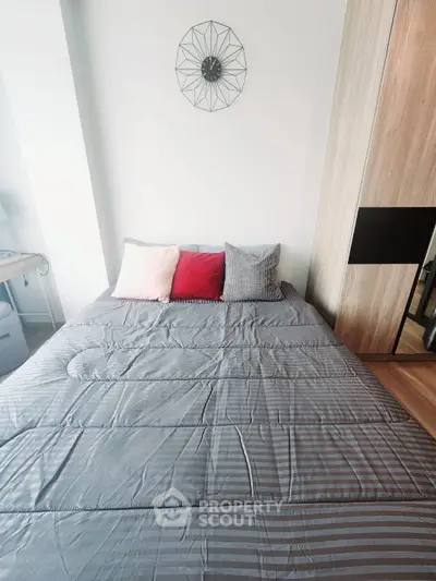 Cozy bedroom with modern decor and stylish bedding in a contemporary apartment.