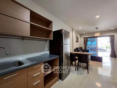 Modern open-plan kitchen and living area with sleek design and natural light