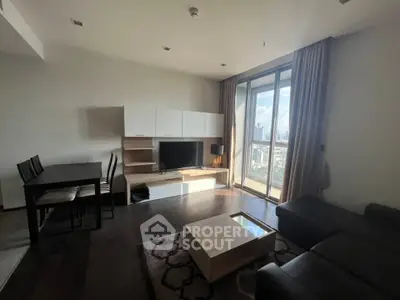 Modern living room with city view, stylish furniture, and natural light.