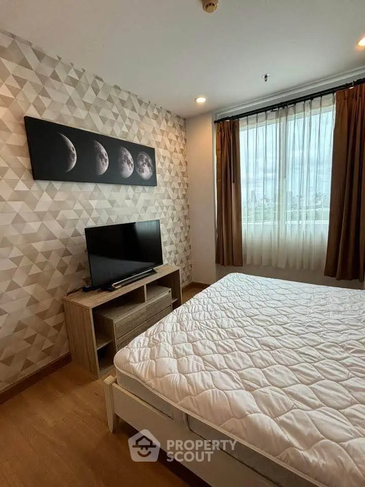 Modern bedroom with geometric wallpaper and city view from window