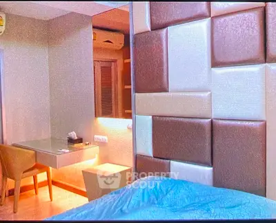 Modern bedroom with stylish wall paneling and cozy workspace