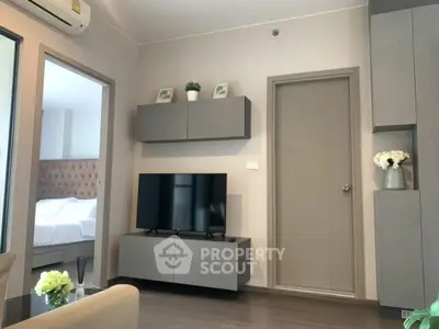 Modern living room with sleek furniture and wall-mounted TV in stylish apartment