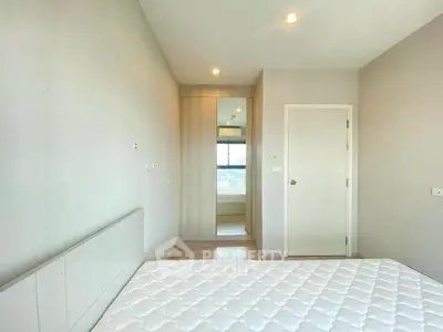 Modern bedroom with large window and minimalist design