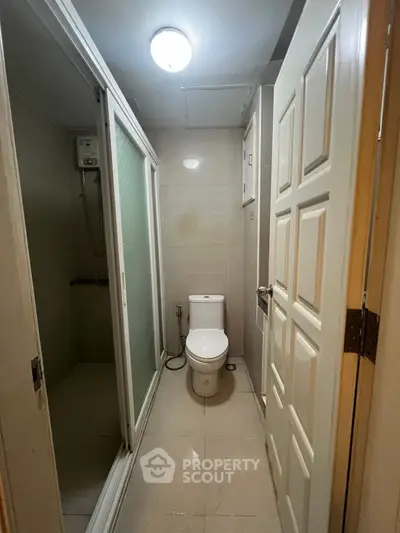Compact bathroom with shower and modern fixtures in a cozy apartment.