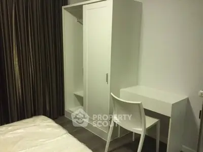 Cozy bedroom with modern white furniture and elegant curtains