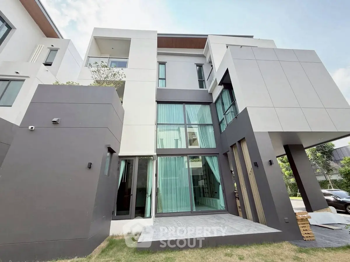 Modern multi-story house with large windows and sleek design