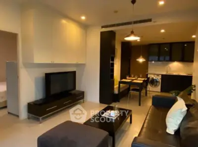 Modern living room with open kitchen and stylish furniture in a cozy apartment.
