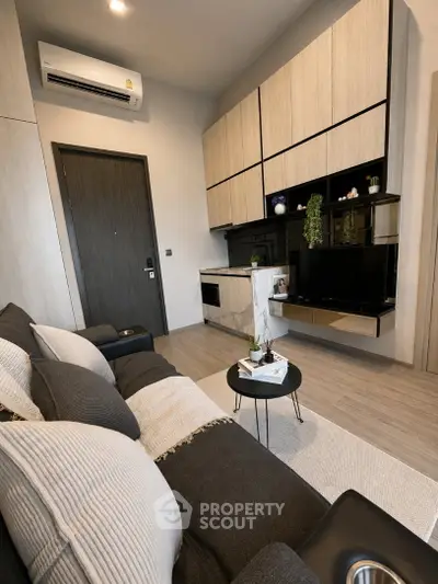 Modern living room with sleek design, featuring a cozy sofa, stylish TV unit, and elegant decor.
