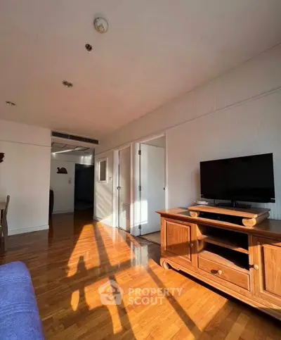 Spacious living room with wooden floors and modern TV stand