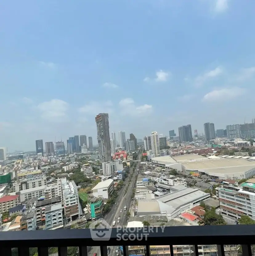 Stunning cityscape view from a high-rise balcony overlooking urban skyline.
