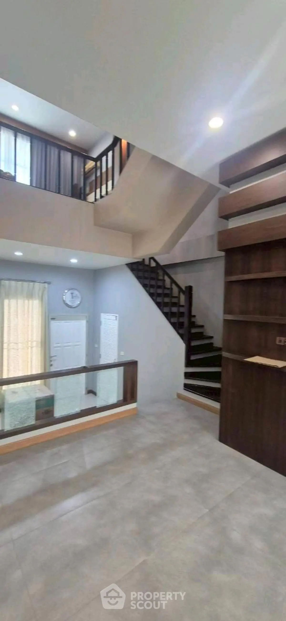 Spacious modern interior with open staircase and natural light