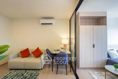Modern living room with cozy sofa, dining area, and air conditioning in stylish apartment.