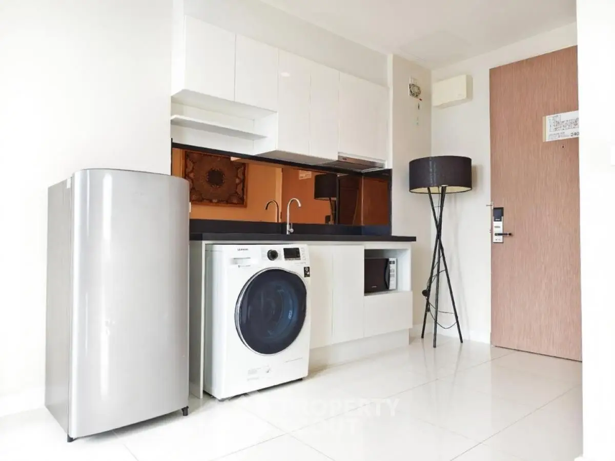 Modern kitchen with sleek appliances and stylish decor in a contemporary apartment.