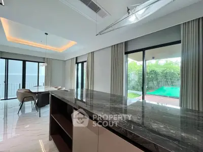 Luxurious modern living room with marble countertop and garden view