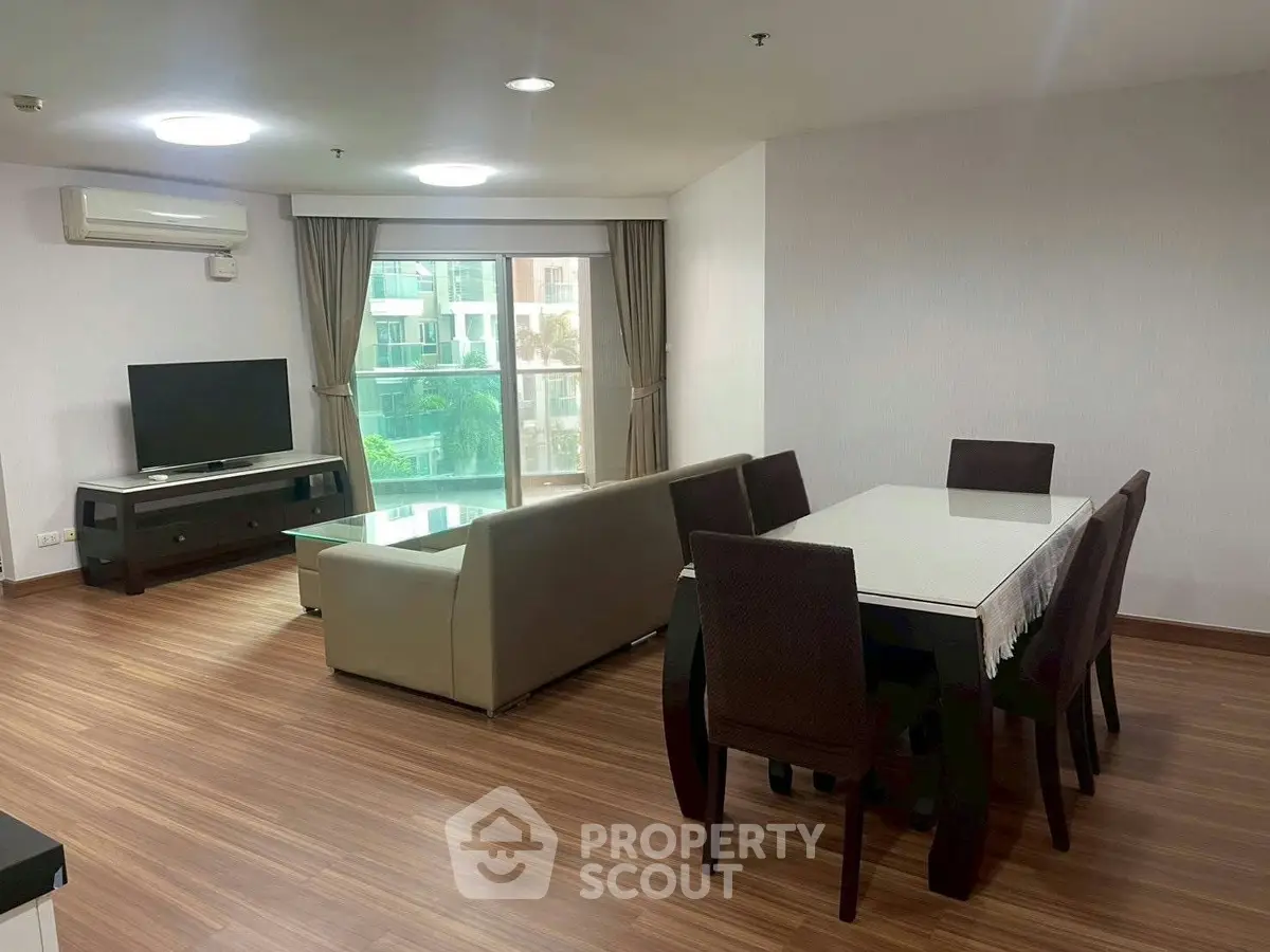 Spacious living room with modern dining area and large window view