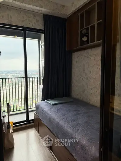 Cozy bedroom with single bed and balcony view in modern apartment