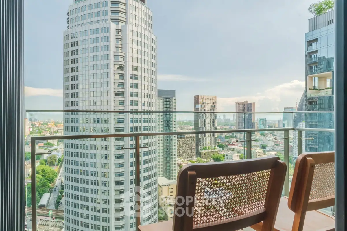 Stunning cityscape view from a modern balcony with elegant seating, perfect for urban living.