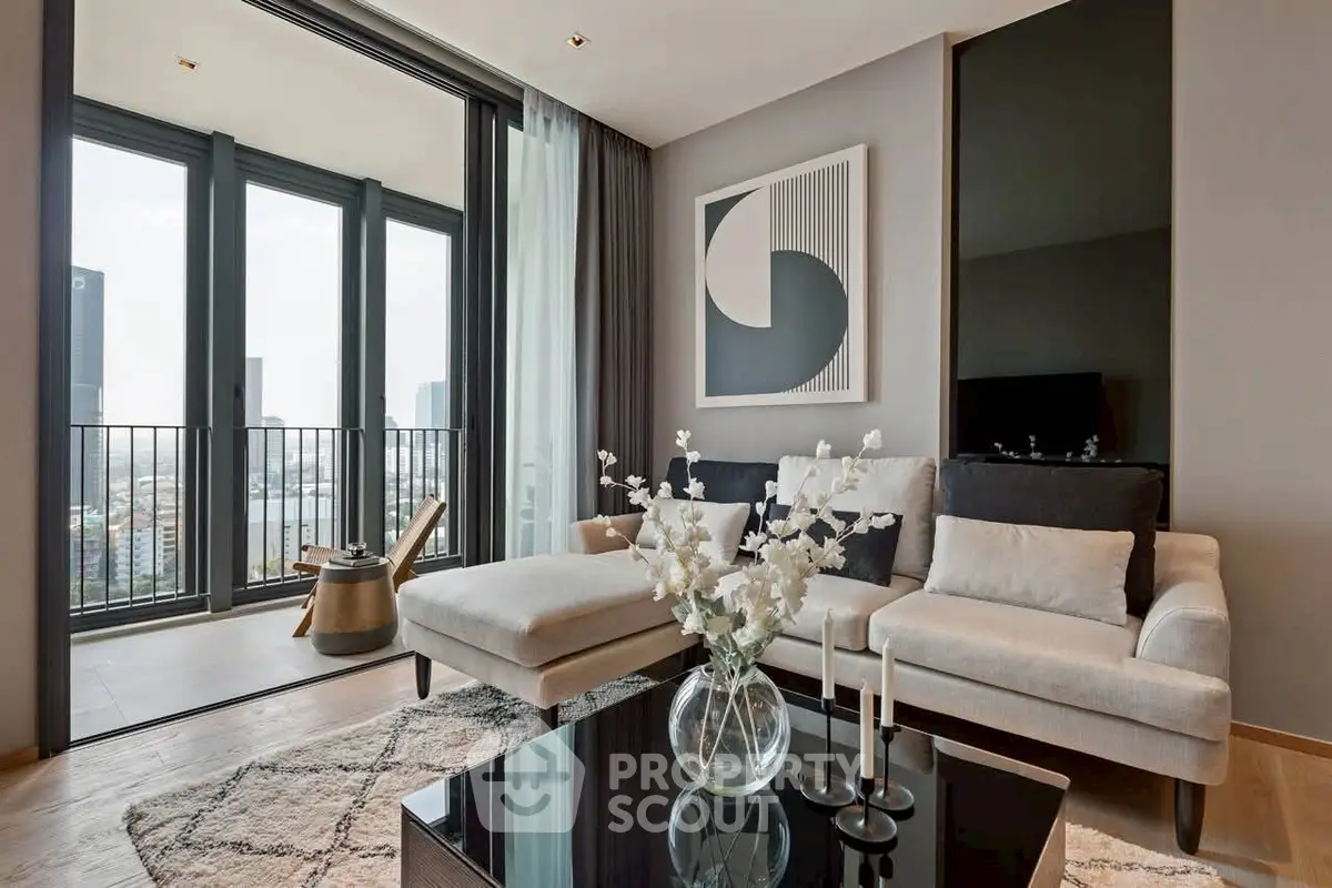 Modern living room with elegant decor and city view balcony, featuring a stylish sofa and contemporary artwork.