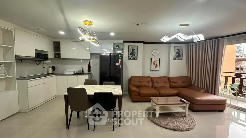 Modern open-layout living room with stylish kitchen and cozy seating area.