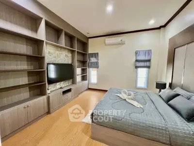Spacious bedroom with built-in shelves and modern decor