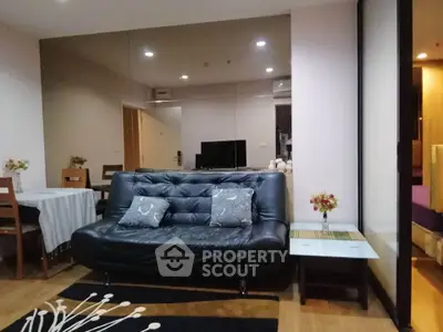 Modern living room with stylish black leather sofa and elegant decor