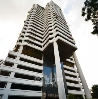 Stunning modern high-rise building with unique architectural design and lush greenery.