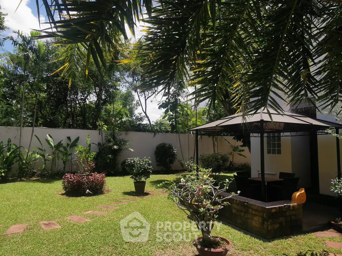 Beautiful garden with lush greenery and a charming gazebo, perfect for outdoor relaxation.
