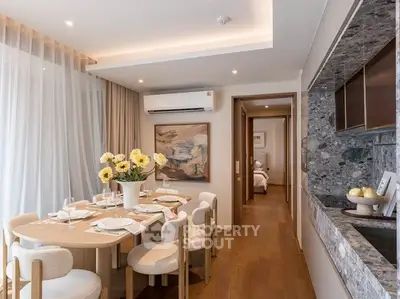 Elegant dining area with modern decor and open kitchen layout in a stylish apartment.