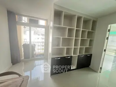 Modern study room with built-in shelving and balcony access