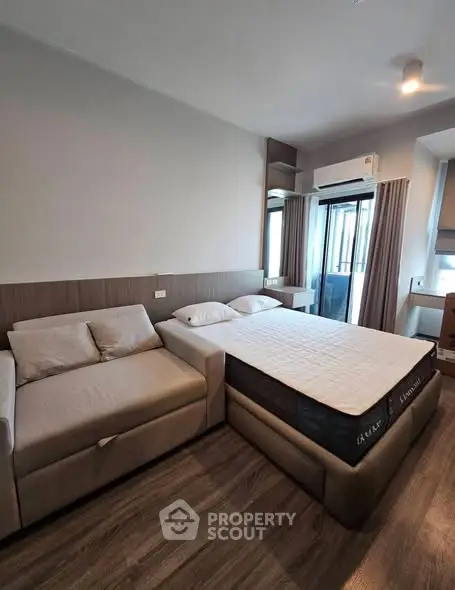 Modern bedroom with stylish furniture and natural light, featuring a cozy bed and sleek design.