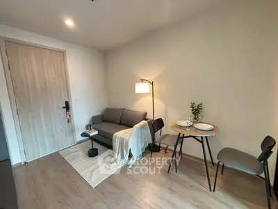 Cozy living room with modern furniture and dining area in stylish apartment.