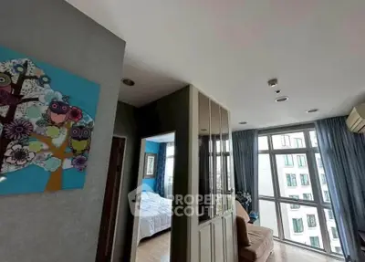 Spacious modern apartment with large windows and stylish decor in a vibrant urban setting.
