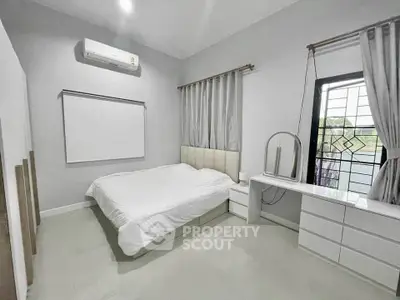Modern bedroom with sleek white furniture and natural light
