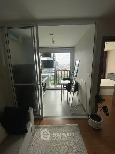 Modern apartment with balcony offering stunning city views, featuring sleek interior design and natural light.