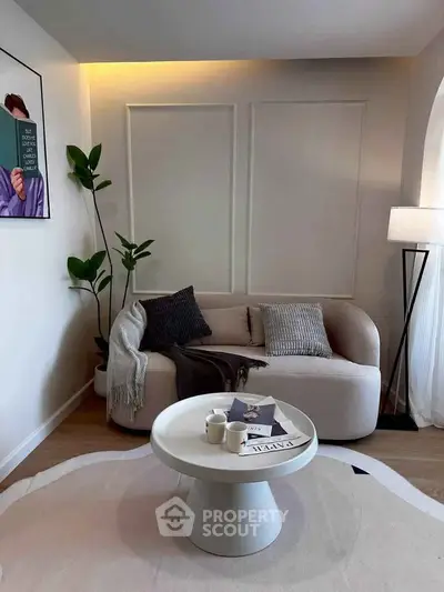 Chic modern living room with cozy sofa, stylish coffee table, and elegant decor.