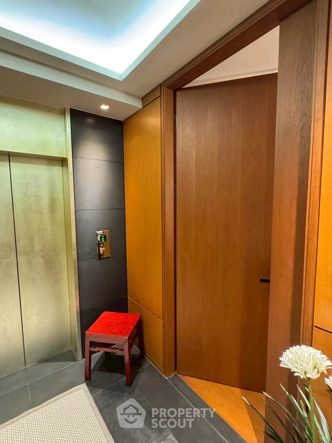 Elegant elevator entrance with modern wood paneling and stylish decor
