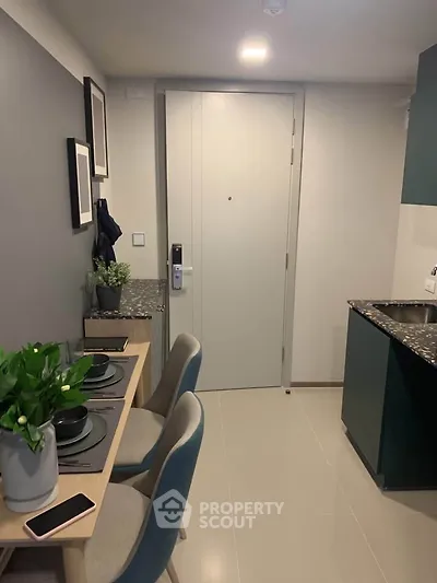 Modern compact kitchen with dining area in stylish apartment