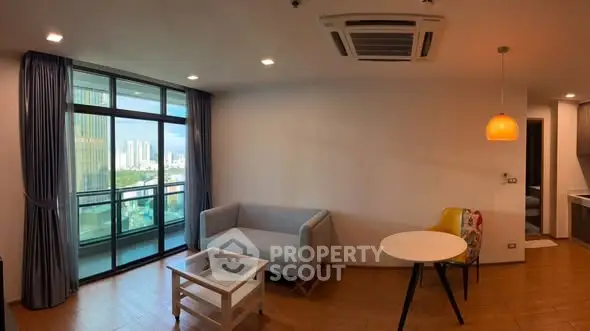 Modern living room with balcony view and stylish furniture