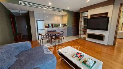 Modern open-plan living room with sleek kitchen and cozy seating area.