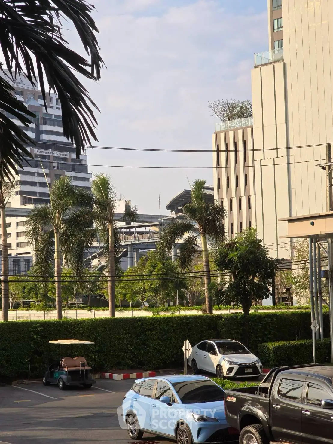 Urban view with modern buildings and parked cars in a city setting