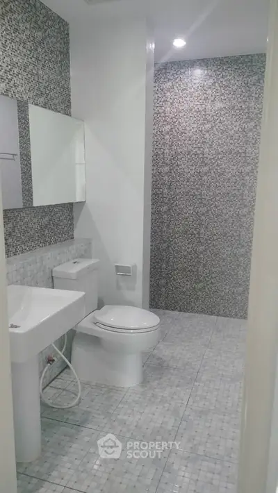 Modern bathroom with sleek design and mosaic tile walls