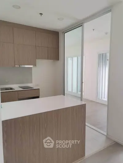 Modern kitchen with sleek wooden cabinetry and open layout design