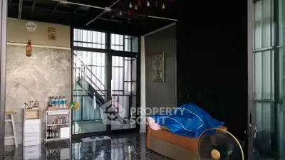 Stylish industrial-style living room with modern decor and unique lighting.