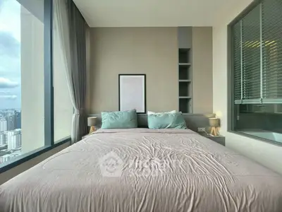 Modern bedroom with large window offering city view and stylish decor.