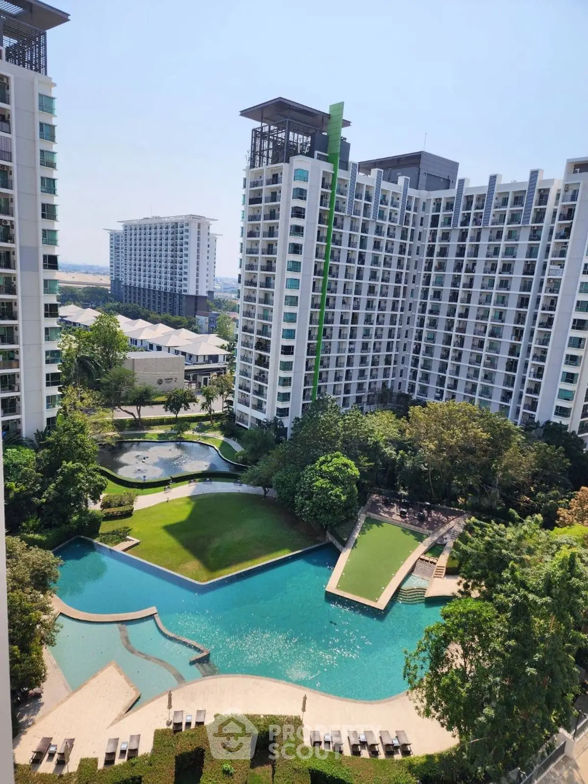 Luxurious high-rise building with stunning pool and landscaped garden view.