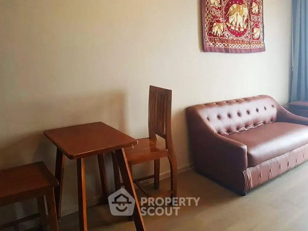 Cozy living room with elegant brown sofa and wooden dining set, perfect for modern living.