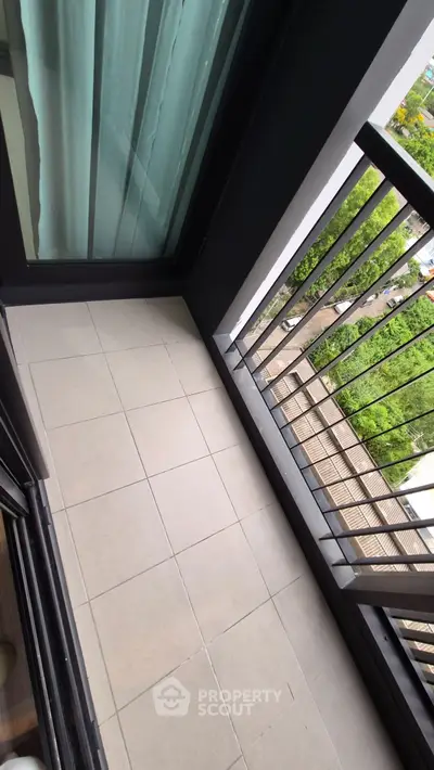 Modern apartment balcony with sleek railing and city view.