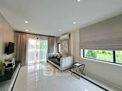 Spacious modern living room with large windows and elegant decor